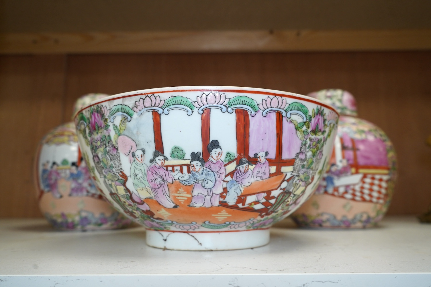 A 20th century Chinese famille rose bowl and a pair of jars and covers, bowl 26cm diameter. Condition - good